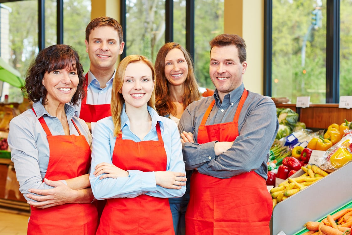 Happy Staff Team in Supermarket